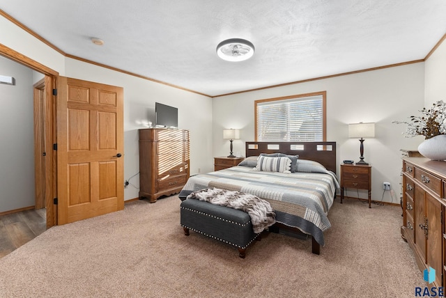 bedroom featuring baseboards, light carpet, and crown molding