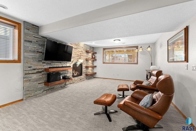 living room with carpet floors, a fireplace, and baseboards