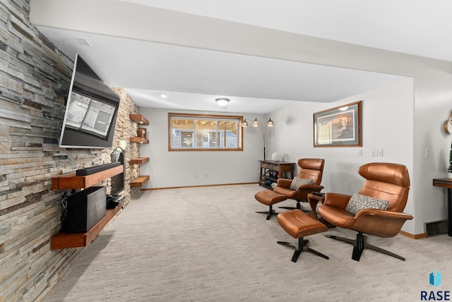 sitting room featuring baseboards, a fireplace, visible vents, and carpet flooring