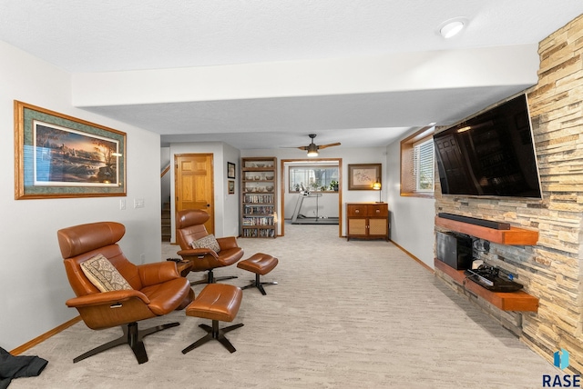 sitting room with carpet floors, baseboards, a fireplace, and stairway