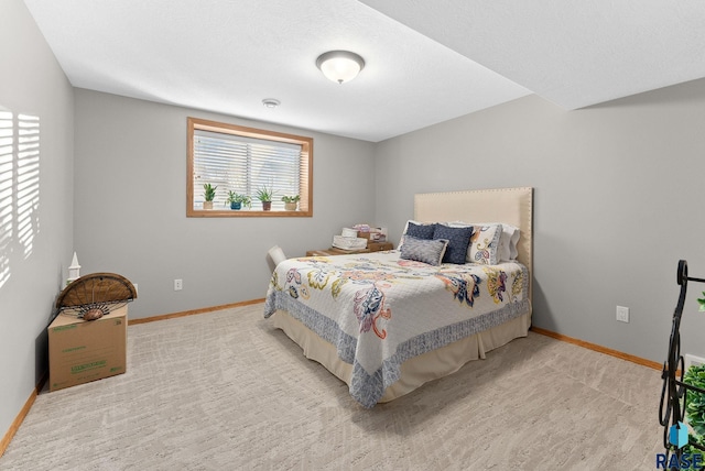 carpeted bedroom featuring baseboards