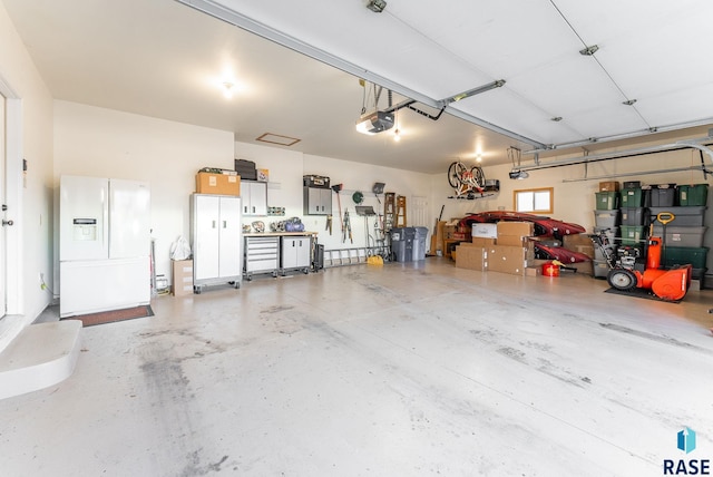 garage with white fridge with ice dispenser and a garage door opener