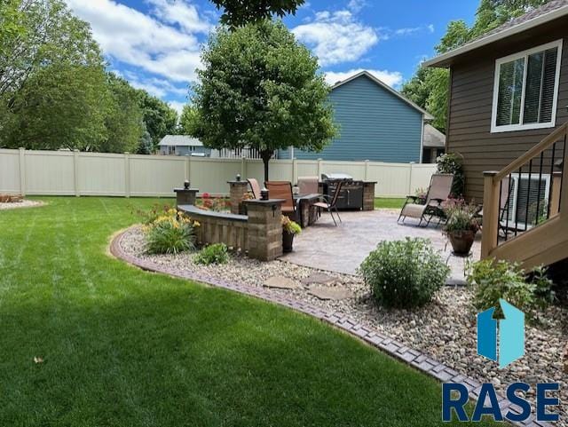 view of yard with a patio and a fenced backyard