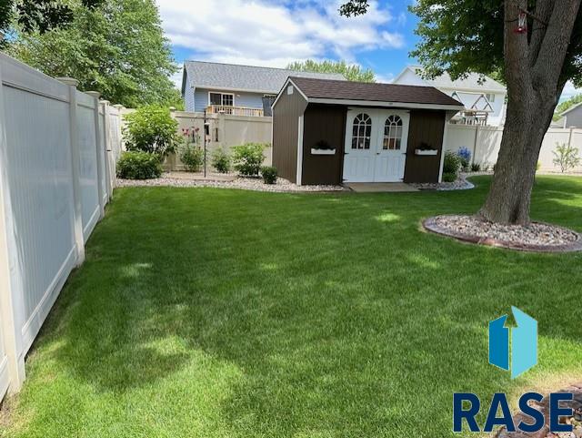 exterior space with a storage shed, an outdoor structure, and a fenced backyard