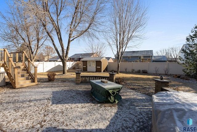 view of yard featuring a patio area, a fenced backyard, and an outdoor structure