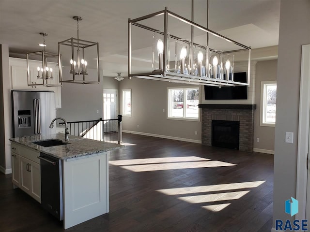 kitchen featuring high quality fridge, white cabinetry, dark wood-style flooring, and a sink