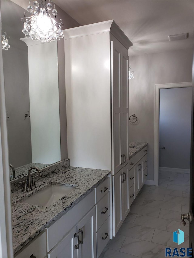 bathroom featuring marble finish floor, visible vents, a chandelier, and vanity