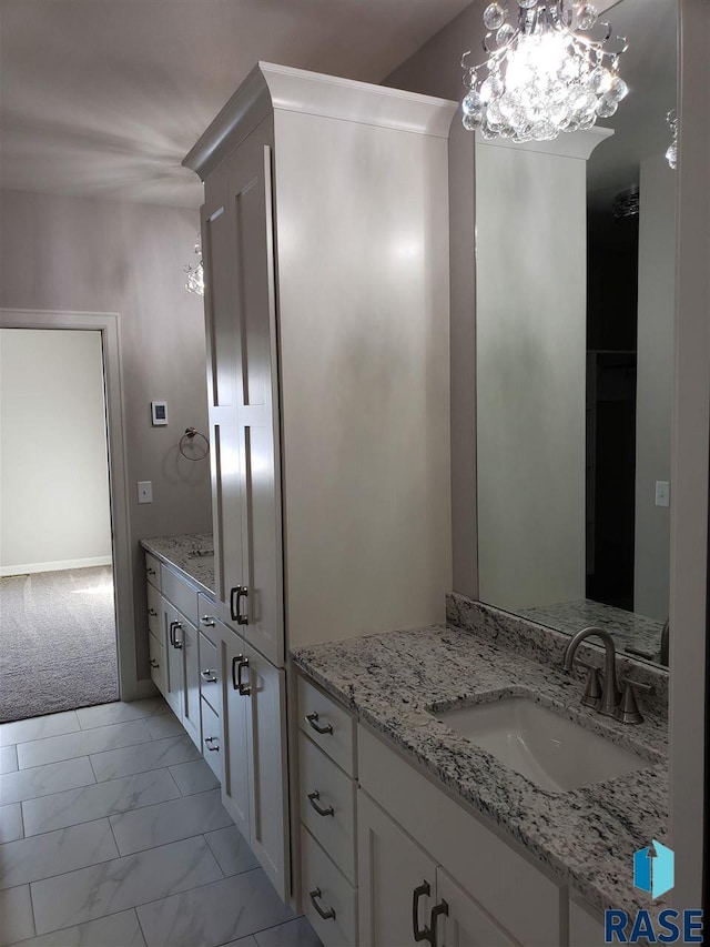 bathroom featuring marble finish floor and vanity