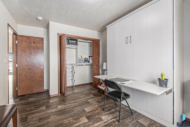 office featuring a textured ceiling and dark wood finished floors