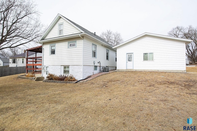 back of house with fence and central AC unit