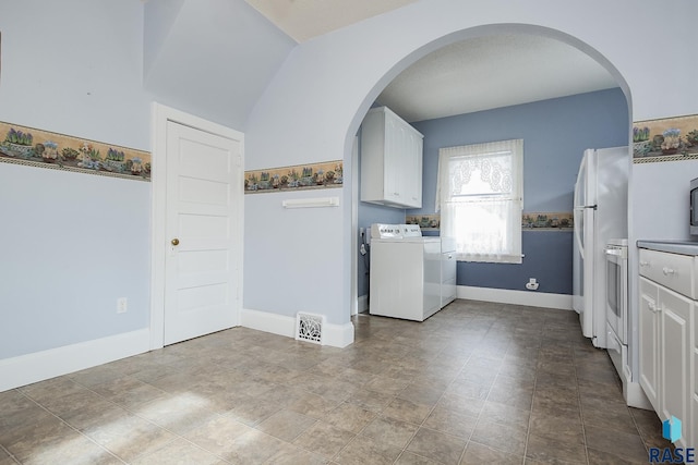 clothes washing area featuring arched walkways, laundry area, washer and clothes dryer, and baseboards