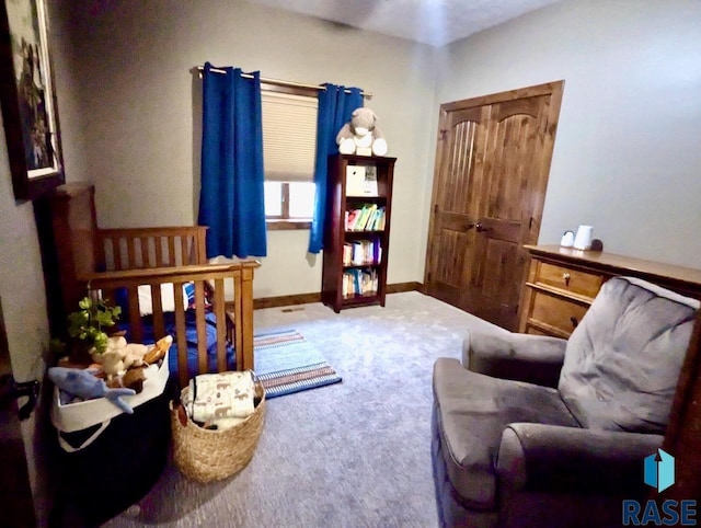 sitting room featuring carpet and baseboards