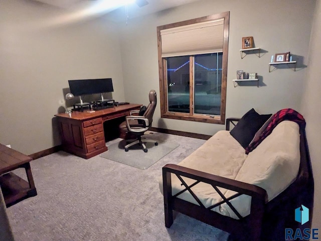 carpeted home office featuring baseboards