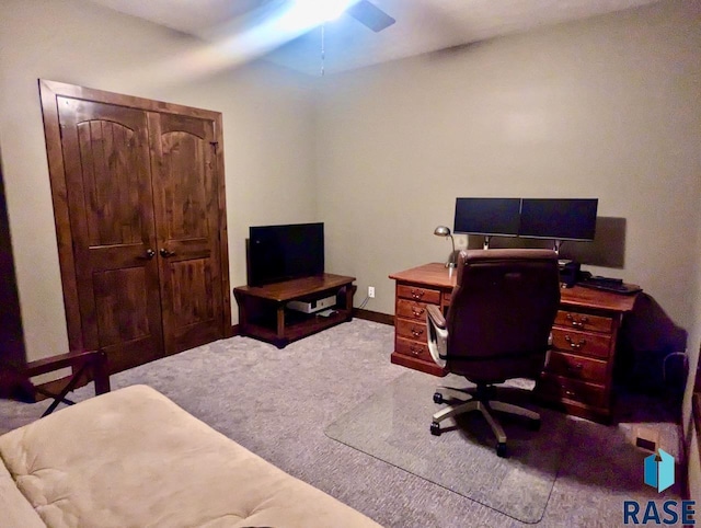 carpeted office featuring baseboards