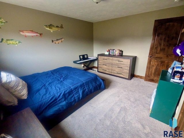 bedroom featuring carpet flooring and baseboards