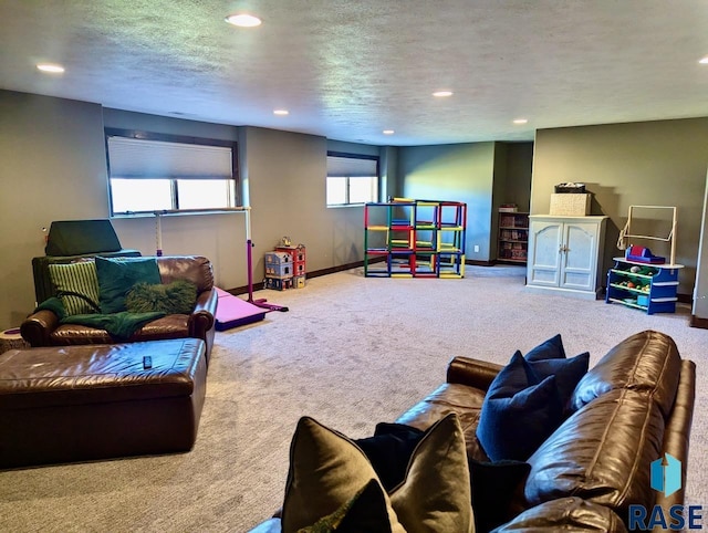 recreation room featuring a textured ceiling, carpet floors, recessed lighting, and baseboards