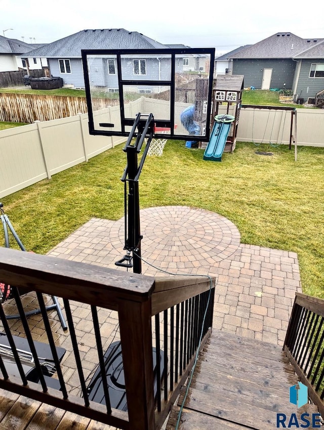 view of patio / terrace featuring a fenced backyard, a residential view, and a playground