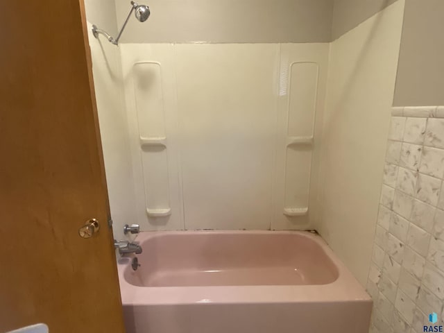 full bathroom with shower / bath combination and tile walls