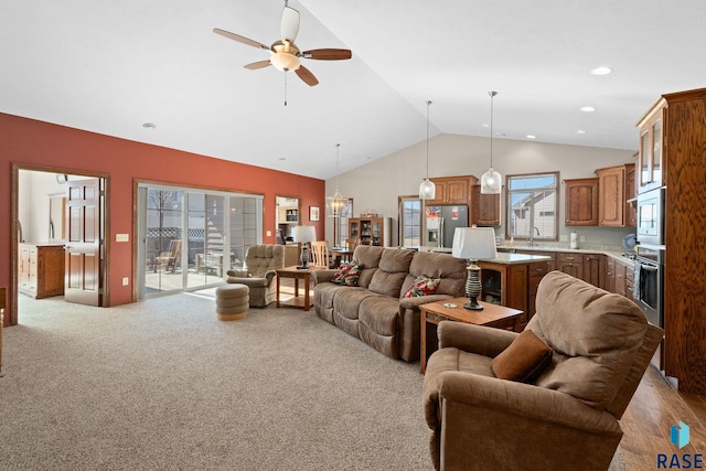 living area with recessed lighting, ceiling fan, high vaulted ceiling, and light colored carpet