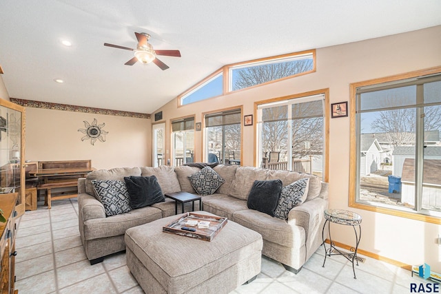 living room featuring a healthy amount of sunlight, baseboards, a ceiling fan, and lofted ceiling