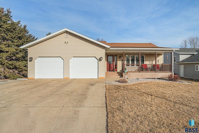 single story home featuring driveway, covered porch, a garage, and a front lawn