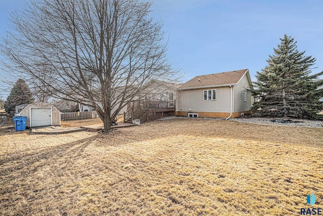 exterior space featuring an outbuilding, a storage shed, central AC, fence, and stairs