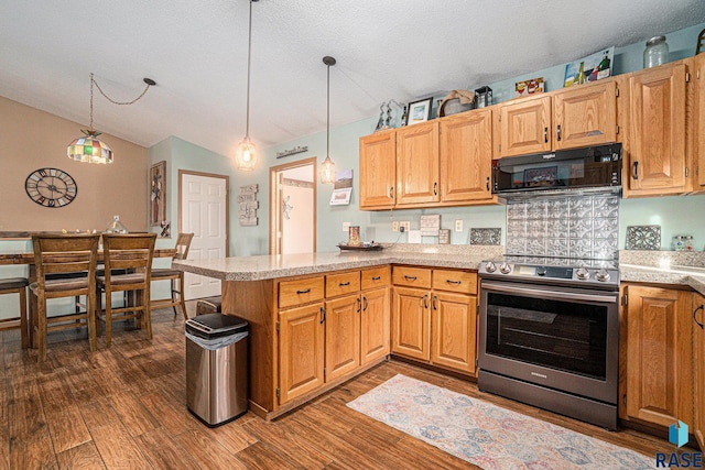 kitchen with dark wood-style flooring, stainless steel electric stove, light countertops, black microwave, and a peninsula