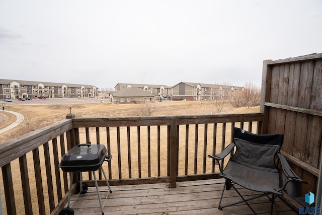 deck with a residential view and area for grilling