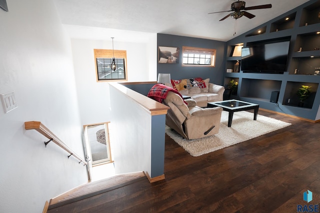 living room with ceiling fan, built in shelves, vaulted ceiling, and wood finished floors