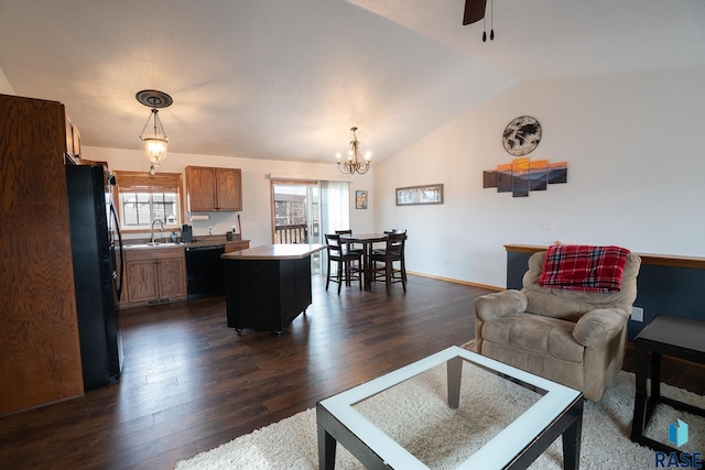 living area with lofted ceiling, plenty of natural light, baseboards, and dark wood finished floors