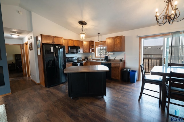 kitchen featuring lofted ceiling, black appliances, pendant lighting, and dark wood-style flooring