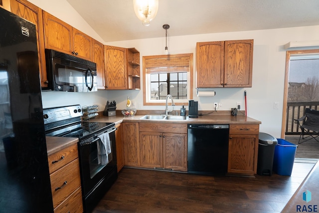 kitchen with black appliances, dark wood-style flooring, a sink, and brown cabinets