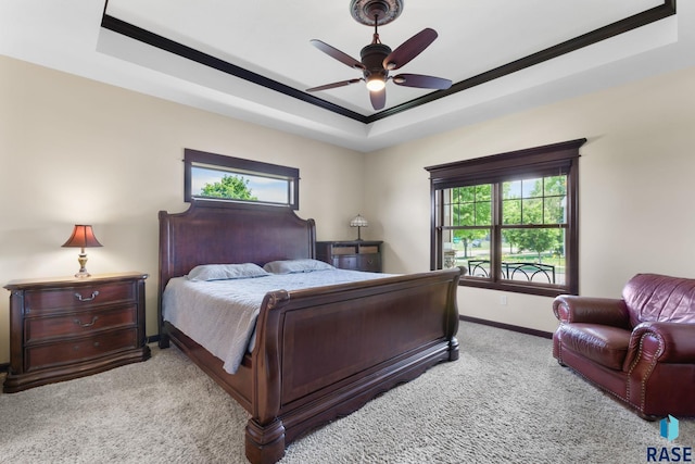 bedroom featuring a tray ceiling, baseboards, ceiling fan, and carpet