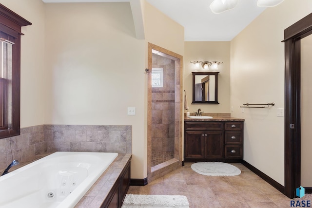 bathroom with baseboards, a jetted tub, vanity, and a stall shower