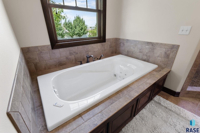 bathroom with a whirlpool tub and tile patterned floors