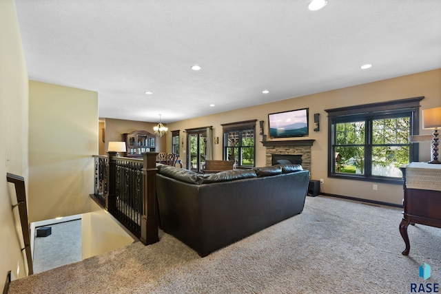 living area featuring carpet, a fireplace, recessed lighting, an inviting chandelier, and baseboards