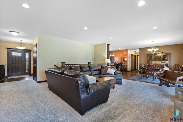 living area featuring carpet floors, recessed lighting, baseboards, and an inviting chandelier