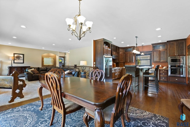 dining space with dark wood-style floors, a notable chandelier, and recessed lighting