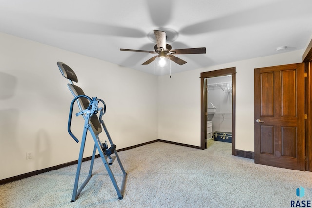 workout area featuring light colored carpet and baseboards