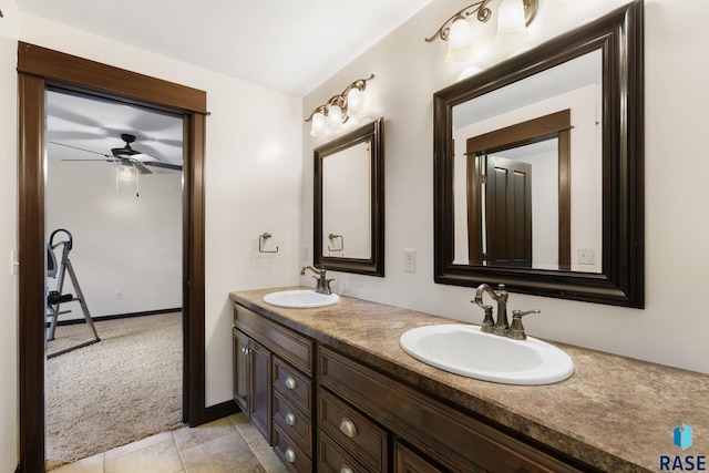 bathroom featuring ceiling fan, tile patterned flooring, a sink, and double vanity