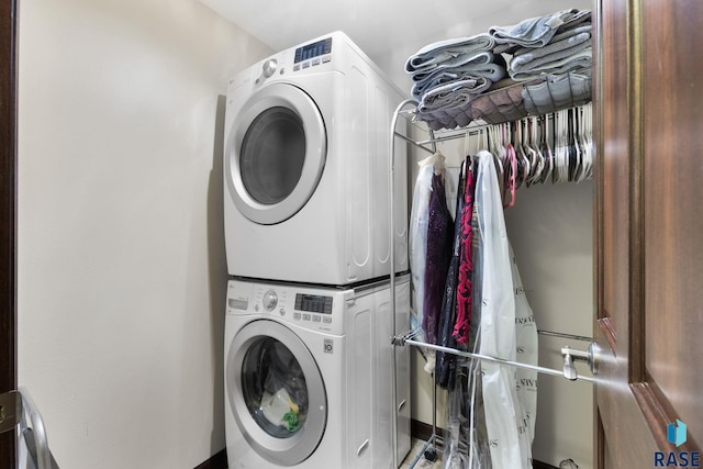 laundry area with laundry area and stacked washer / drying machine