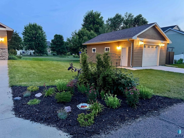 view of front facade with a garage, a front yard, and fence