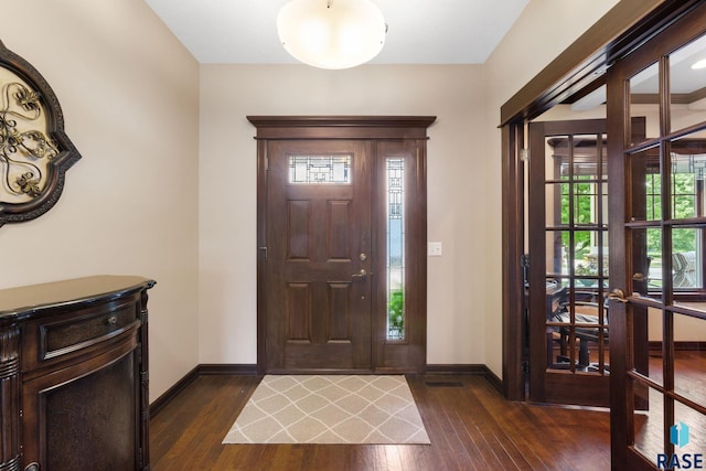 entryway with baseboards and dark wood-type flooring