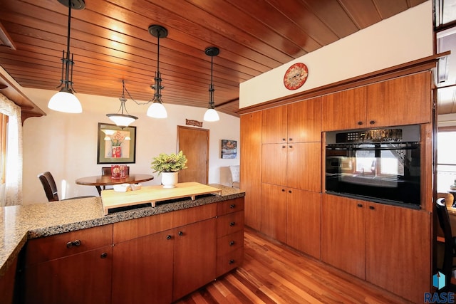 kitchen with hanging light fixtures, wooden ceiling, wood finished floors, and oven