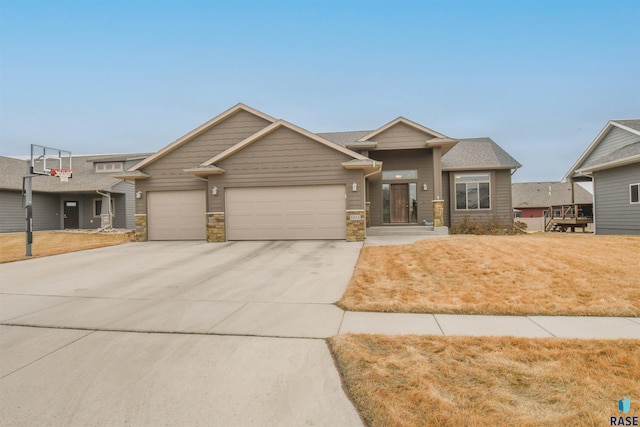 view of front of house featuring concrete driveway, stone siding, a front lawn, and an attached garage