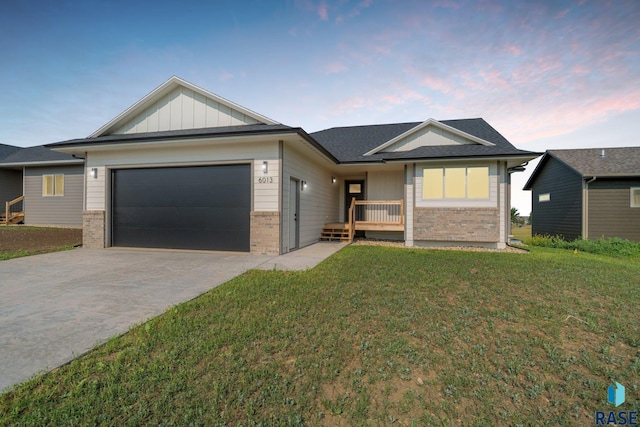 ranch-style house with decorative driveway, board and batten siding, and brick siding