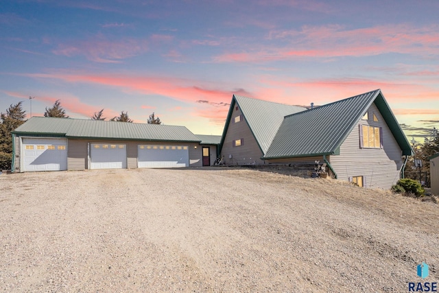 a-frame home with metal roof and driveway