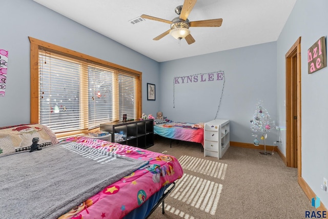 carpeted bedroom with visible vents, ceiling fan, and baseboards