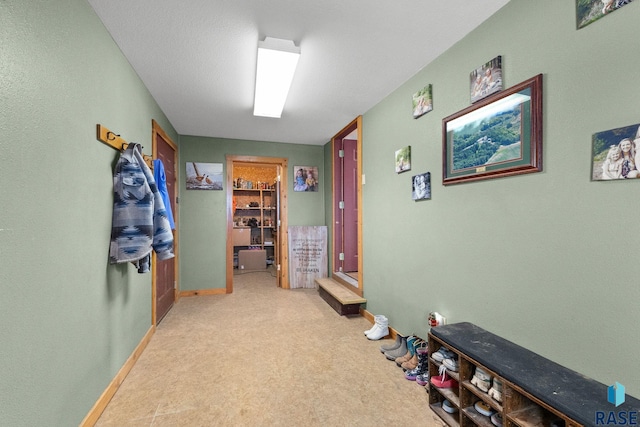 interior space featuring carpet and baseboards