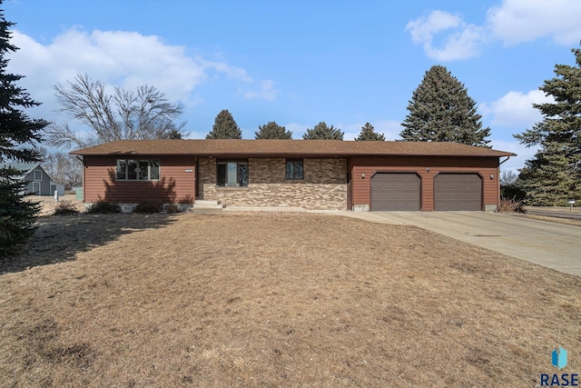 ranch-style house with a garage and concrete driveway